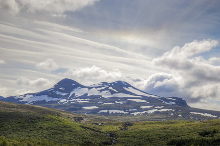 The picture shows a mountain landscape in Iceland in which a halo can be seen.の写真素材