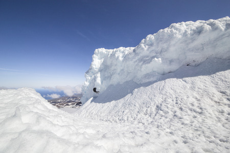The picture shows a snow wall on the Snaefellsjokull in Iceland, which is interspersed with...