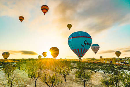 Colorful hot air balloons landing over stunning nature landscape of Cappadocia, Turkey, October 2019のeditorial素材