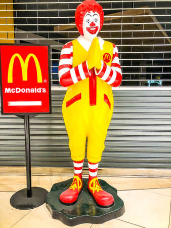 Thai McDonald mascot is standing in front of closed shop, Bangkok, Thailand, May 2020