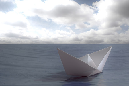 Paper boat floating in the seaの写真素材
