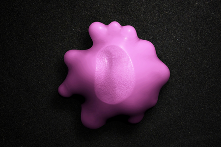 Pink bubble gum stuck to a surface with fingerprintの写真素材