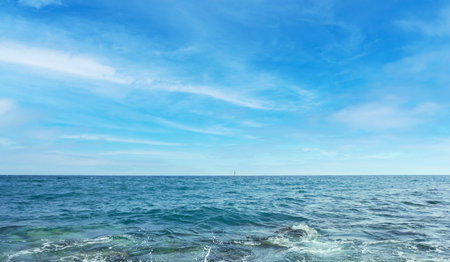 Blue sea and sky with clouds