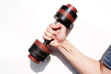 Mans hand, holding in hand a dumbbell.の写真素材