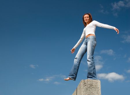 Girl balancing above a precipice-1の写真素材
