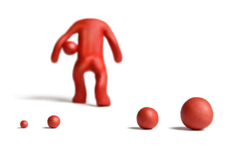 Red plasticine man figure on a white background の写真素材