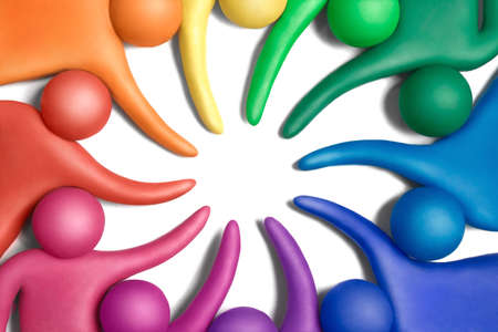 Multicolored plasticine human figures organized in a circle