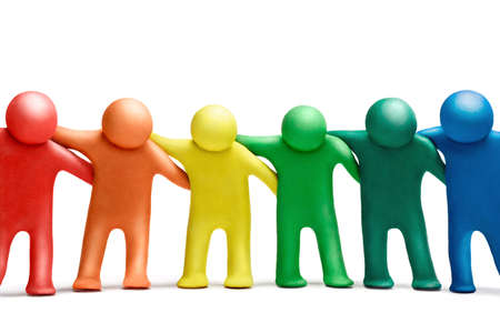 Multicolored  plasticine human dancing figures arranged in a row