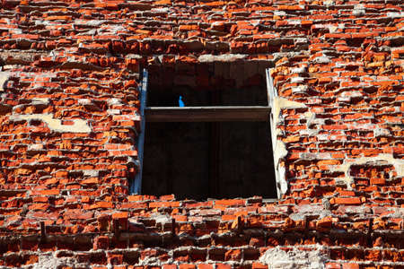 Window and brick wall of a ruined houseの写真素材