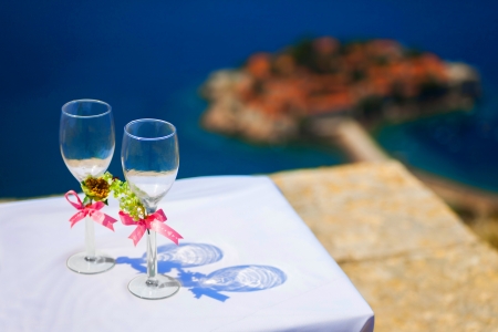 Wedding wineglasses on background of S Stefan island Montenegro の写真素材