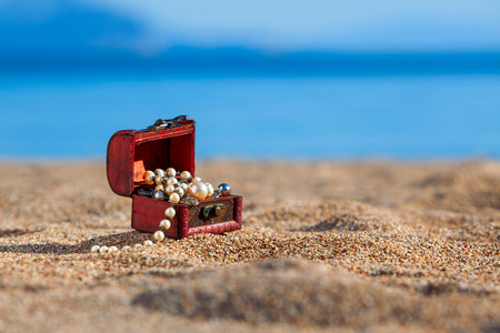 Decorative chest with jewelry  on a beachの写真素材
