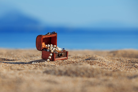 Decorative chest with jewelry  on a beachの写真素材