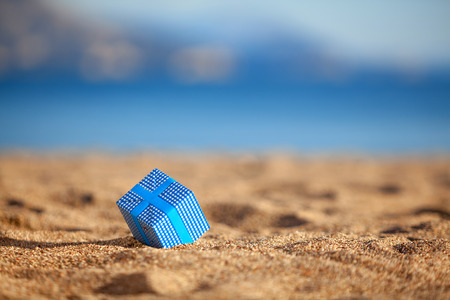 Blue gift box on a beachの写真素材