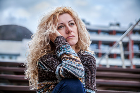 Sad woman on a streetの写真素材