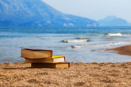 Closed books on a beachの写真素材