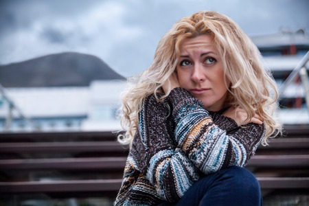 Sad woman on a streetの写真素材