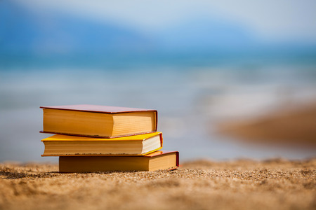 Closed books on a beachの写真素材