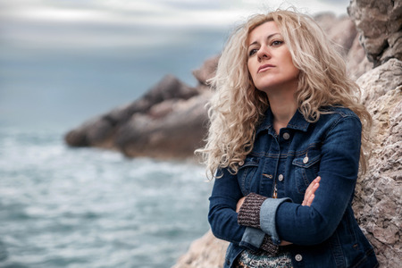 Sad woman on a seasideの写真素材