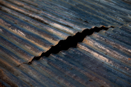 Cracked tin plate as a backgroundの写真素材