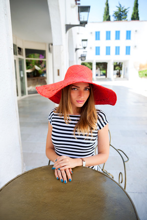 Beautiful woman sitting  in a summer cafeの写真素材