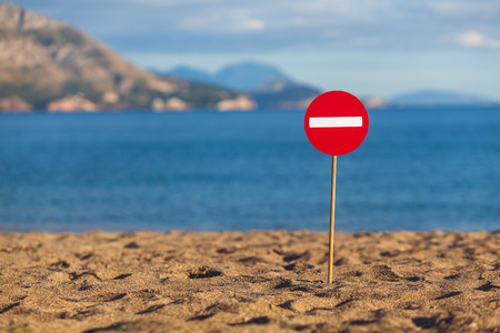 A road sign installed on a sandy beachの写真素材