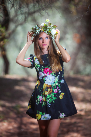 Young pretty woman in a olive forestの写真素材