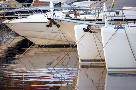 A fragment of yacht marina with yachts bows