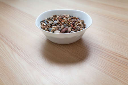 Plate full of gravel and sand on a tableの写真素材