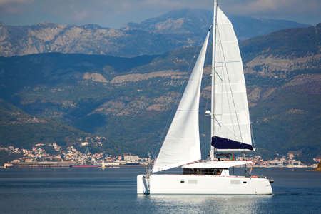 Sailing catamaran in Tivat bay in Montenegroの写真素材