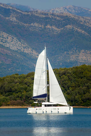 Sailing catamaran in Tivat bay in Montenegroの写真素材
