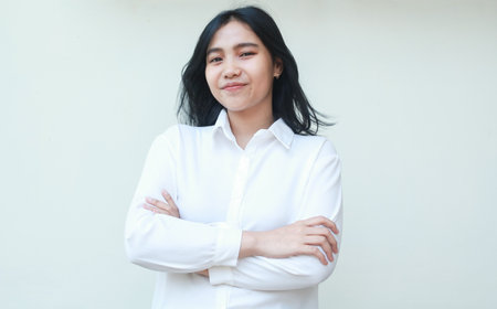 image of confident asian business woman success entrepreneur standing with crossed arms looking at camera smiling wear white formal suit shirt isolated on white backgroundの写真素材