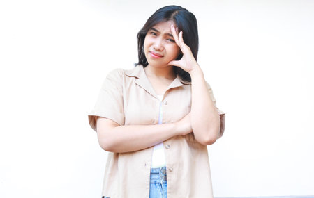 confused asian woman hold her head feels stressed and overwhelmed wearing casual clothes isolated on...