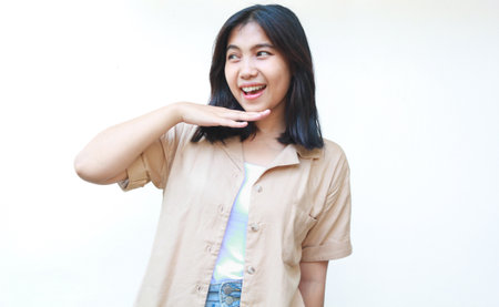 happy calm asian woman smiling confident wearing casual brown clothes isolated on white backgroundの写真素材