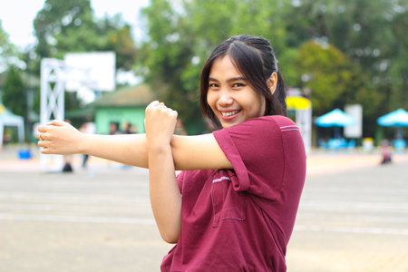 happy asian woman stretching hands in outdoor warm up before play basketballの写真素材