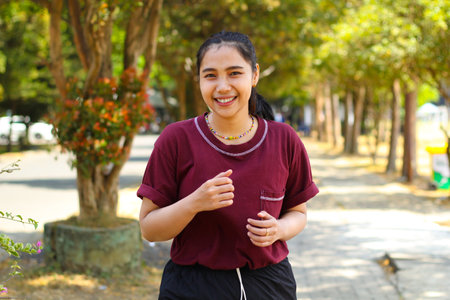 relax asian woman jogging in midday in outdoors, female running to practice cardio