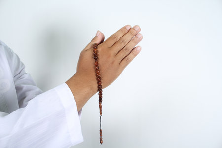 muslim hands in greeting gesture with holding prayer beads isolated
