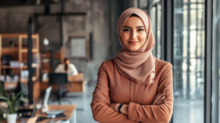 A portrait of a confident Muslim businesswoman in a modern office setting. She exudes professionalism and success.の素材