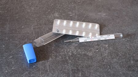 medicines and thermometer for fever