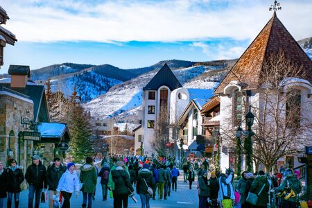 Vail, Colorado/USA-December,30,2018. Vail village,small town at base of Vail Mountain,gateway for winter sports. People walking next to stores and restarants,mountains in background.のeditorial素材