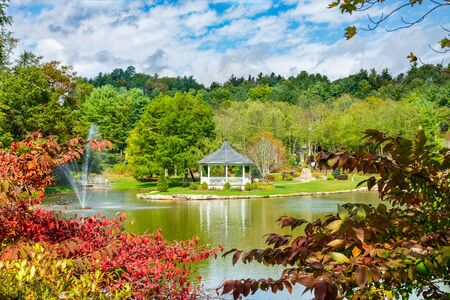 Mayview lake in autumn colors. Beautiful lake with gazebo and fountain on autumn morning. Broyhill Park, Blowing Rock, near Blue Ridge Parkway, North Carolina, USA.の写真素材
