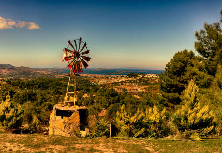 Old windmill on the hillside at sunset, Crete, Greeceの写真素材