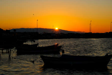 Fishing boats on the sea at sunset in the city of Limassol, Cyprusの写真素材