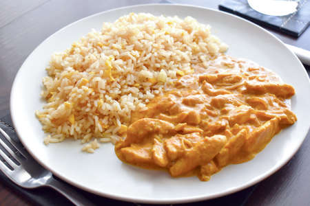 Chicken Korma with egg fried rice on a plate. Traditional Indian food.  Indian chicken curry.