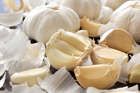 Garlic cloves on wood table background. Alternative medicine. Cooking preparation concept.