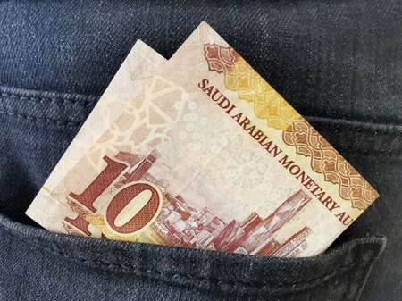 10 Saudi Riyal banknote in the back pocket of jeans.