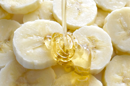 Banana and honey on a white plate.  Healthy and dietary food concept.の写真素材