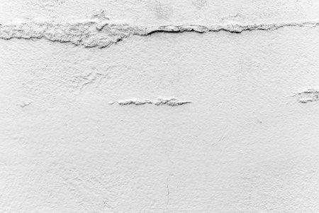 Dirty old uneven grunge white painted concrete wall texture background. Rough surface cement backdrop.の写真素材