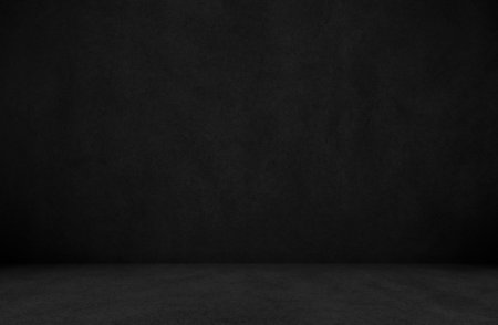 Empty dark black concrete studio room for displaying product background. Interior black cement wall...
