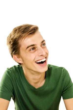 Closeup portrait of a happy young man smiling on white background の写真素材