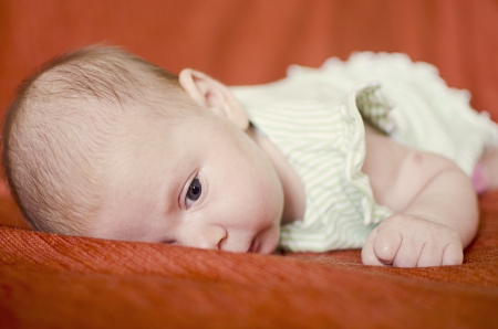 Portrait of a baby laying on her tummy